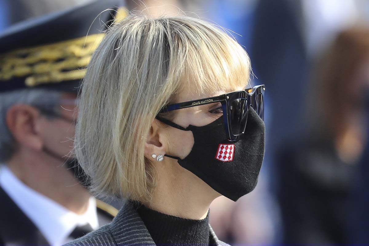 Princess Charlene of Monaco wears a mask bearing the flag of the Monaco principality during a ceremony in Nice, southern France, in homage to the three victims of an attack at Notre-Dame de Nice Basilica on Oct. 29, Saturday Nov. 7, 2020.