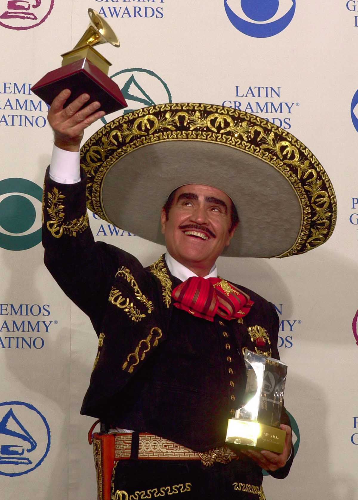 Mexico's Vicente Fernandez holds up the award he won for best ranchero album for "Mas Con El Numero Uno" at the 3rd annual Latin Grammy Awards Wednesday, Sept. 18, 2002, in Los Angeles.