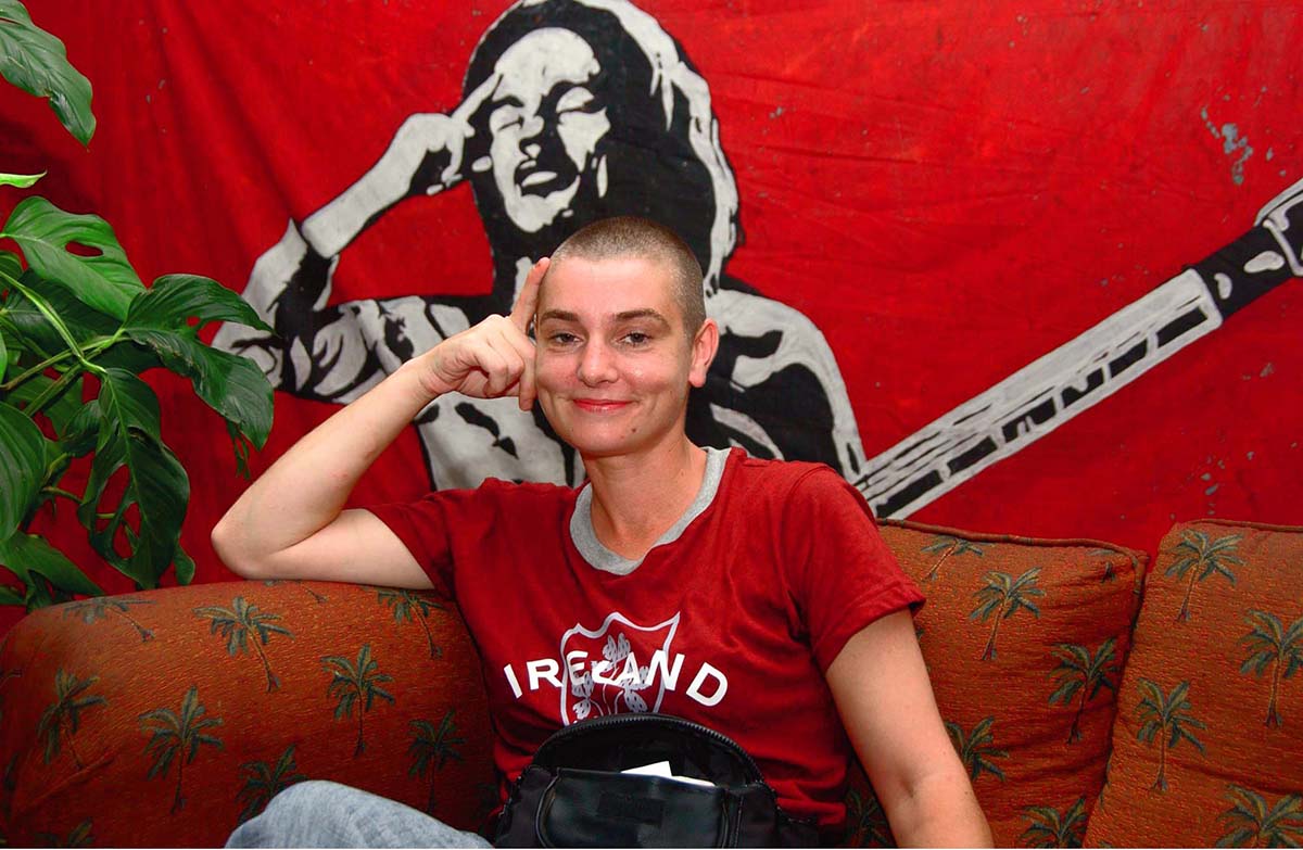 Irish pop singer Sinead O'Connor smiles during the launching of her album "Throw Down Your Arms," scheduled to be released in September, Monday, Aug. 8, 2005 in Kingston, Jamaica. She recorded the album in Kingston earlier this year with several top Jamaican musicians, including drummer Sly Dunbar, bassist Robbie Shakespeare, guitarist Mikey Chung and trombonist Nambo Robinson. (AP PHOTO/Collin Reid )
