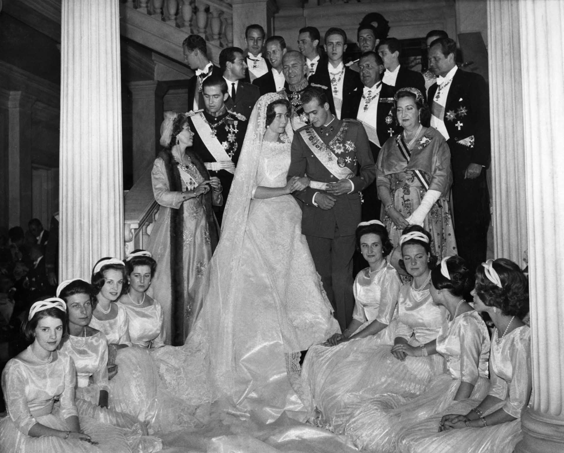 Princess Sophie of Greece and Crown Prince Don Juan Carlos are pictured with their eight bridemaids and relatives at the Royal Palace in Athens, Greece, following wedding ceremonies, May 14, 1962. King Paul, wearing the full dress uniform of a field marshal, stands behind the bridal couple. Great Britain's Princess Alexandra is seen fourth from the left.