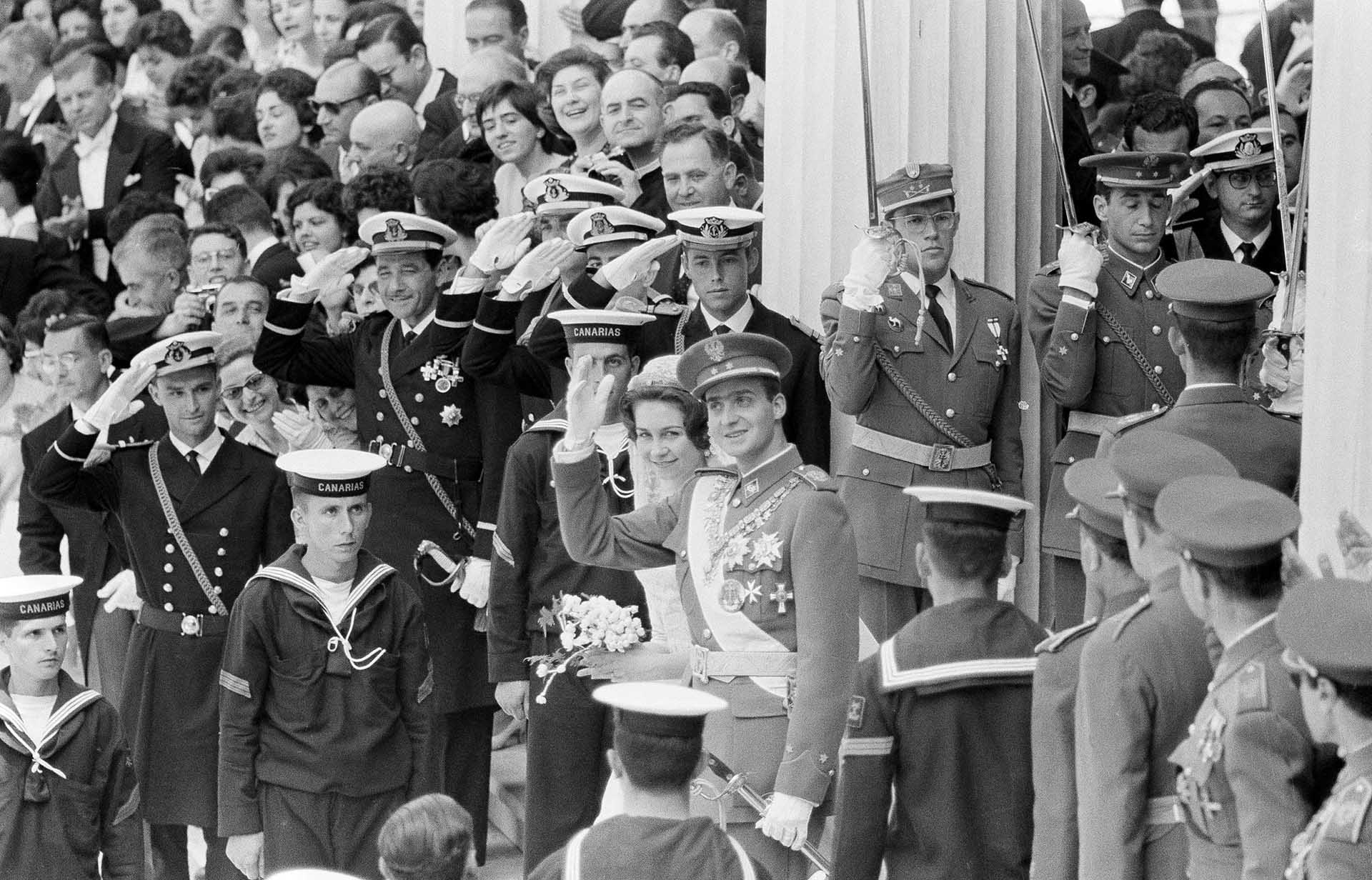 Prince Juan Carlos of Spain, with his bride, Princess Sophia of Greece, waves to onlookers in Athens, Greece, May 14, 1962, following wedding ceremony at St. Denis Roman Catholic Cathedral. (AP Photo/Pool)
