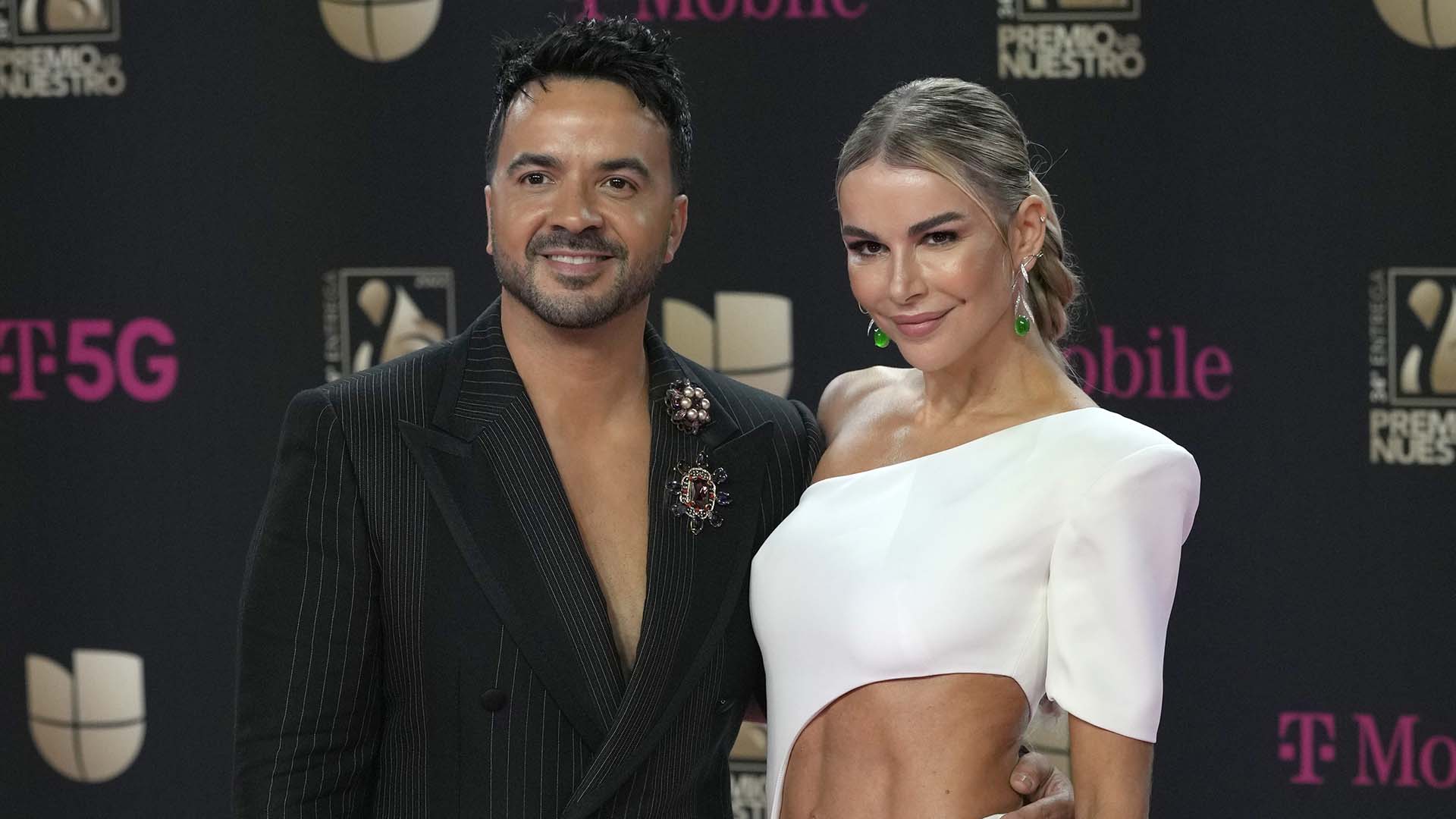 Luis Fonsi, left, and Agueda Lopez arrive at Premio Lo Nuestro at FTX Arena in Miami on Thursday, Feb. 24, 2022.  *** Local Caption *** .