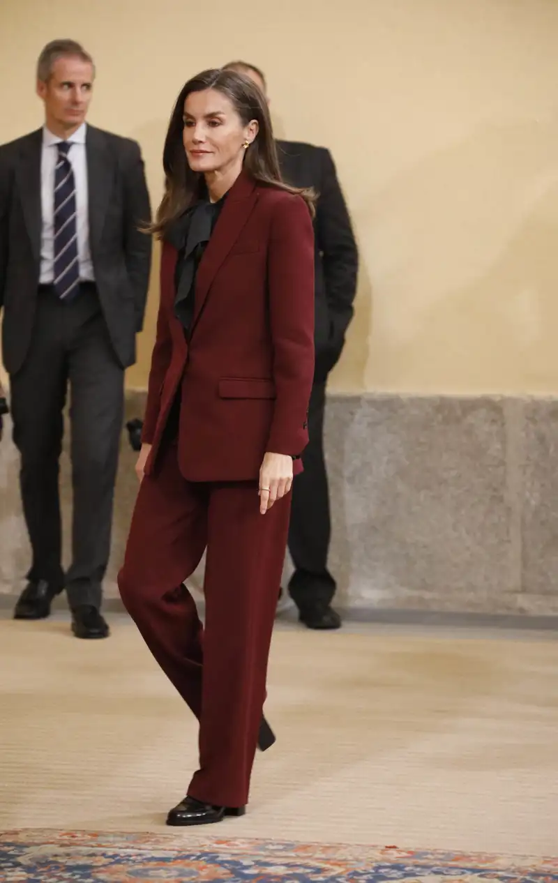 El nuevo traje burdeos de la Reina Letizia y su camisa con lazada al cuello más de moda 