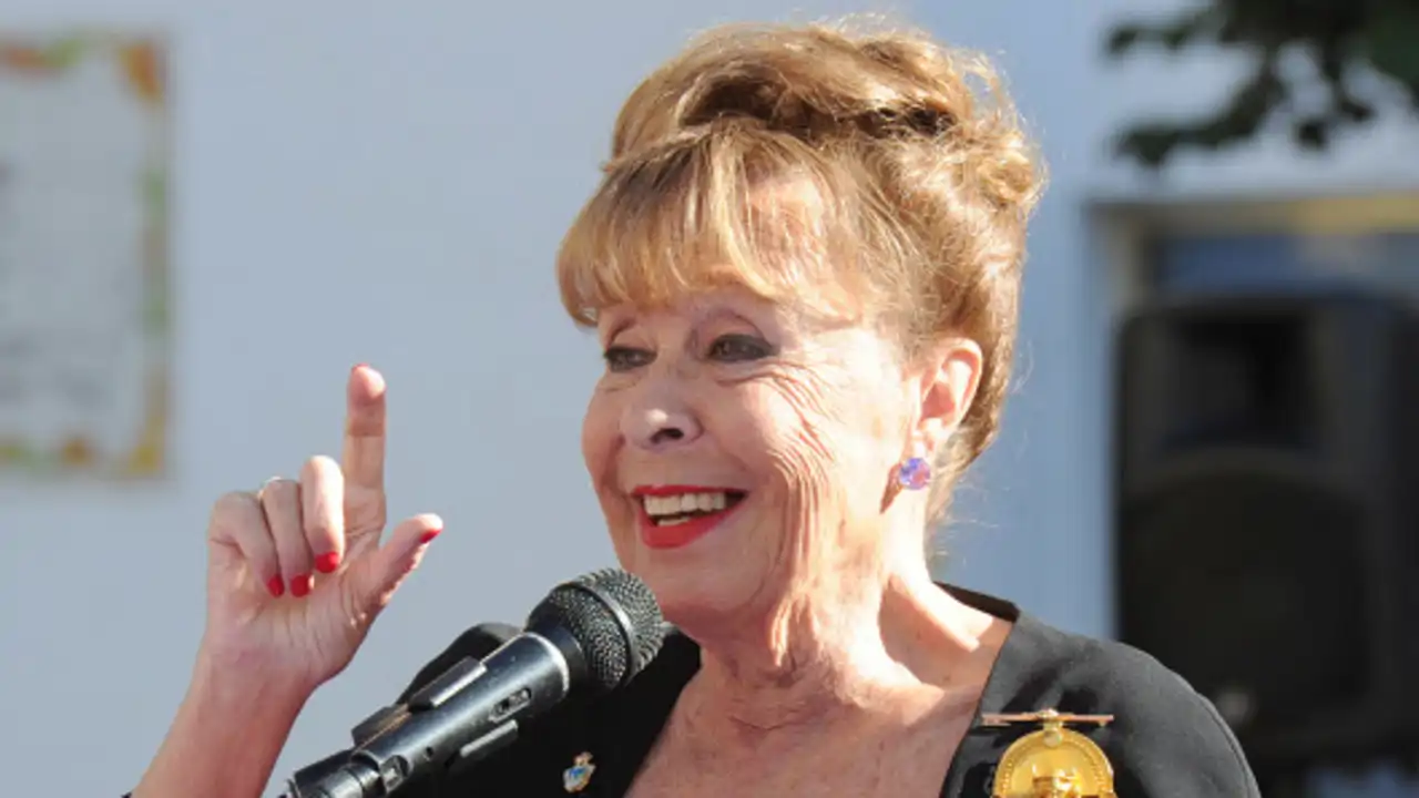 Gemma Cuervo entonando unas palabras frente a un micrófono en un homenaje