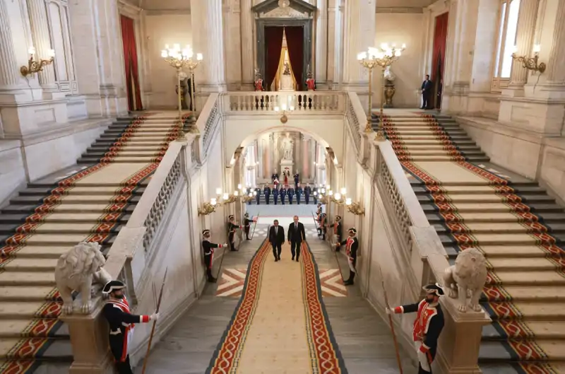 El Rey Felipe y el presidente de Portugal subiendo los escalones del Palacio Real